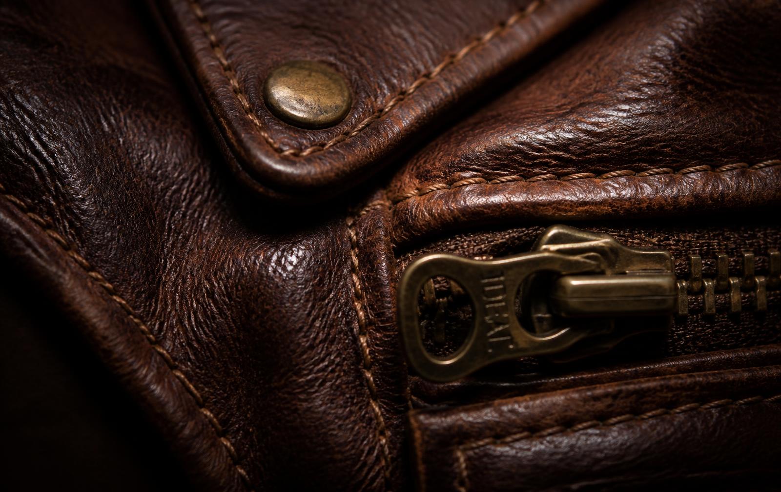 Close-up of stitched full-grain leather and brass hardware